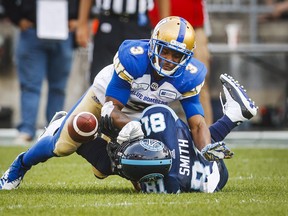 Toronto Argonauts' Rodney Smith has a pass broken up by Winnipeg Blue Bombers' Kevin Fogg during second-half action in Toronto on Saturday, July 21, 2018. (MARK BLINCH/THE CANADIAN PRESS)
