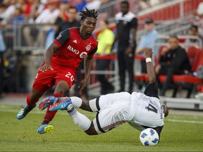 Toronto FC's Ayo Akinola battles for the ball with Ottawa Fury FC's Nana Attakora, right, during the first half of Canadian Championship soccer action in Toronto, Wednesday July 25, 2018. THE CANADIAN PRESS/Mark Blinch