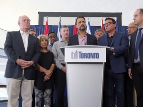 Councillor Justin Di Ciano, centre, and other Toronto councillors show solidarity to Premier Doug Ford's announcement to reduce city council to 25 wards in Toronto, Ont. on Friday July 27, 2018. Dave Abel/Toronto Sun
