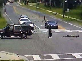 In a video released by Hillsborough County Sheriff’s officials, a driver of an SUV vehicle is seen picking up an unconscious woman who fell out of the vehicle at a Florida intersection. (Twitter)