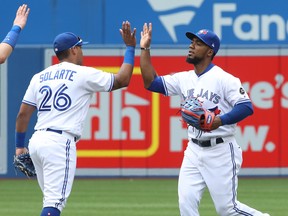 The Jays' Teoscar Hernandez celebrates their victory with Yangervis Solarte at Rogers Centre  yesterday. (Getty Images)