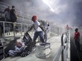 Toronto FC fans are ejected from TD Place after a flare was thrown on to the field during second half of the Canadian Championship between Ottawa Fury FC and the TFC on Wednesday. THE CANADIAN PRESS