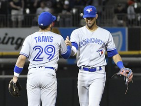 Devon Travis (left) and Lourdes Gurriel Jr. of the Toronto Blue Jays celebrate their team's win against the Chicago White Sox on July 27, 2018. (DAVID BANKS/Getty Images)