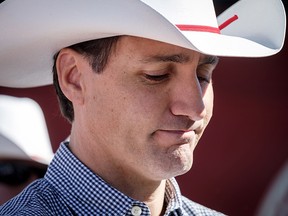 Prime Minister Justin Trudeau listens to speeches as he attends a pancake breakfast in Calgary on Saturday, July 7, 2018. (THE CANADIAN PRESS/Jeff McIntosh)