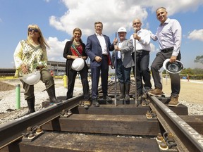 Politicians (L-R) Frances Nunziata, Laura Albanese Liberal MPP for York South-Weston, Toronto mayor John Tory, Frank Di Giorgio city councillor, Steve Del Duca Ontario Liberal Transportation Minister and Josh Colle TTC chair stand on the first tracks laid by Metrolinx for the Eglinton LRT on Aug. 9, 2017. (Jack Boland/Toronto Sun)