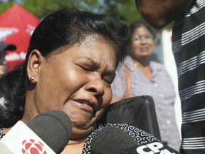 Ranjini Suthesan breaks down while speaking at a Wednesday press conference seeking leads into the murder of her son, Venojan Suthesan, 21. (Veronica Henri/Toronto Sun)
