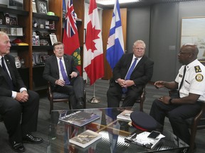 Mayor John Tory meets with Minister of Border Security and Organized Crime Reduction Bill Blair, left, Premier Doug Ford and Police Chief Mark Saunders at Toronto City Hall on Monday, July 23, 2018. (Veronica Henri/Toronto Sun)