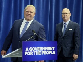 Ontario Premier Doug Ford, left, arrives with Municipal and Housing Minister Steve Clark for a press conference on Friday, July 27, 2018. Veronica Henri/Toronto Sun