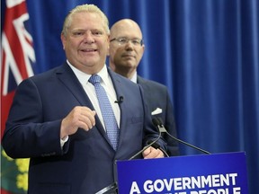 Ontario Premier Doug Ford(L) with Municipal and Housing Minister Steve Clark on Friday July 27, 2018 in Toronto. The  PC government will introduce legislation to cut Toronto city council seats from 47 to 25 and eliminate regional chair elections in elections in Peel, York, Niagara and Muskoka. Veronica Henri/Toronto Sun/Postmedia Network