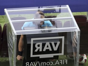 Referee Nestor Pitana checks the VAR before awarding France a penalty shot during the final match between France and Croatia at the 2018 soccer World Cup in the Luzhniki Stadium in Moscow, Russia, July 15, 2018. (THANASSIS STAVRAKIS/AP)