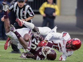 Cornerback Trumaine Washington (right) breaks up a pass intended for Mississippi State wide receiver Reginald Todd (20) during Washington’s college days with Louisville. The rookie will make his debut with the Argonauts on Saturday against the Blue Bombers. (AP/PHOTO)