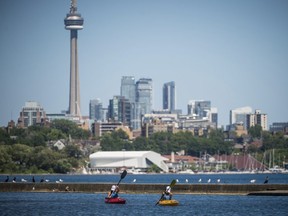 People kayak Lake Ontario near Sir Casimir Gzowski Park in Toronto on Friday, July 6, 2018. (Tijana Martin/The Canadian Press)