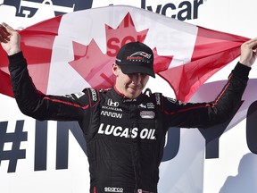 Canadian Robert Wickens celebrates his third-place finish at the Honda Indy in Toronto on Sunday. (Frank Gunn/The Canadian Press)