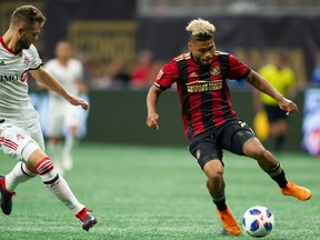 Atlanta United FC striker Josef Martinez tries to get around Toronto FC's Eriq Zavaleta during Saturday's 2-2 draw in Atlanta.