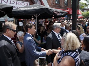 Prime Minister Justin Trudeau greets people after laying flowers in memory of Toronto shooting victims at a memorial on Danforth Ave., on July 30, 2018 in Toronto, Canada. (Photo by Cole Burston/Getty Images)