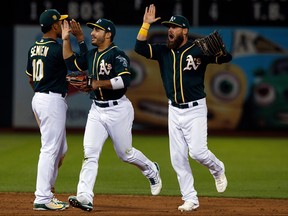 Both Ramon Laureano (middle) and Nick Martini (right) are playing big roles in Oakland's playoff push and could carry that over into starting jobs next season. (Jason O. Watson/Getty Images)