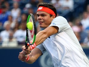 Milos Raonic returns a shots against David Goffin of Belgium during first-round play at the  Rogers Cup at Aviva Centre in Toronto yesterday.  Vaughn Ridley/Getty Images