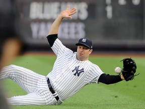 Yankees outfielder Neil Walker attempts to grab a hit by the Blue Jays’ Kevin Pillar in New York last night. Elsa/Getty Images