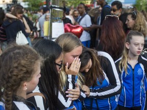 Members of the Markham Synchro club -- murder victim Julianna Kozis, 10, was a member - pay their respects during a vigil at Alexander the Great Parkette on Danforth and Logan Aves on July 25, 2018. The girl was one of two people killed and many injured in a mass shooting on the Danforth earlier this summer. (Ernest Doroszuk, Toronto Sun)
