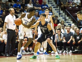 Duke Blue Devils' R.J. Barrett goes up against University of Toronto Varsity Blues' Inaki Alvarez during their exhibition game on Friday. (THE CANADIAN PRESS)