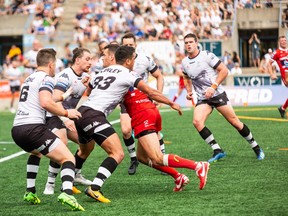 Wolfpack players converge on a player from the Hull Kingston Rovers on Saturday at Lamport Stadium in Toronto. (Photo courtesy of Toronto Wolfpack)