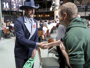 Green Bay Packers quarterback Aaron Rodgers was a busy man yesterday, agreeing to a record-setting contract extension and then greeting people during the Green Bay chamber of commerce ‘Welcome Back Packers’ luncheon. (AP PHOTO)