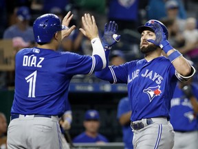 Toronto Blue Jays' Kevin Pillar celebrates with Aledmys Diaz  after hitting a two-run home run during the eighth inning of a baseball game against the Kansas City Royals Tuesday, Aug. 14, 2018, in Kansas City, Mo. (AP Photo/Charlie Riedel)