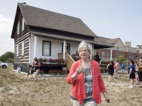 Annette Dionne, one of the two surviving Dionne quintuplets, visits the original cabin she was born in, relocated to downtown North Bay next to the North Bay Museum on Sunday August 5, 2018. THE CANADIAN PRESS/Fred Thornhill