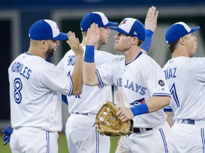 Toronto Blue Jays left fielder Billy McKinney, right, celebrates with teammate Kendrys Morales (8) after defeating the Baltimore Orioles during ninth inning AL baseball action in Toronto on Tuesday, August 21, 2018. THE CANADIAN PRESS/Nathan Denette