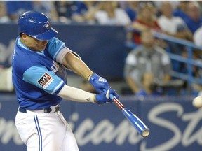 Toronto Blue Jays' Aledmys Diaz hits a three run double against the Philadelphia Phillies during eighth inning Interleague MLB baseball game action to put the Jays ahead by one run Saturday August 25, 2018 in Toronto.