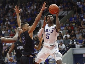 Duke Blue Devils' R.J. Barrett, right, puts up a shot against Ryerson Rams' Nathan Culbreath during their exhibition basketball game in Mississauga on  Wednesday. 
THE CANADIAN PRESS/Mark Blinch