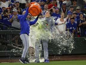Toronto Blue Jays winning pitcher Ryan Borucki, right, is doused after the Blue Jays defeated the Seattle Mariners 7-2 in a baseball game Friday, Aug. 3, 2018, in Seattle. (AP Photo/Ted S. Warren)