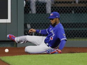 Toronto Blue Jays left fielder fielder Teoscar Hernandez slides on the warning track as he goes after a hit by Kansas City Royals' Hunter Dozier during the fourth inning of a baseball game at Kauffman Stadium in Kansas City, Mo., Thursday, Aug. 16, 2018. Dozier had an RBI double on the play. (AP Photo/Colin E. Braley)