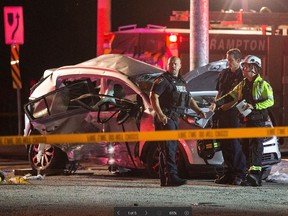 Police at the scene where three people were killed in a crash. (JOHN HANLEY PHOTO)