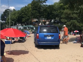 Screen capture of video shot where a man was reversing on a Port Dover beach where people were sunbathing.