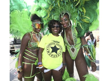 Lisa Phillips, (R) dressed in her Playing in Paradise costume for Carnival Nation poses with her mom Anne Marie (middle) and sister Stacey. Shehas been coming to the carnival since she was a kid and will be 30 later this year. Her mother was at the original one on University Ave. She was part of the The 51st annual Toronto Caribbean Carnival took to the CNE grounds and Lakeshore Blvd.  on Saturday August 4, 2018. Jack Boland/Toronto Sun/Postmedia Network