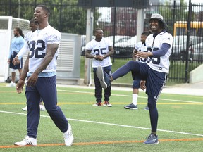 Toronto Argos wide receiver Duron Carter gets in some stretches at practice at Lamport Stadium with teammate James Wilder in Toronto on Wednesday, Aug. 29, 2018.