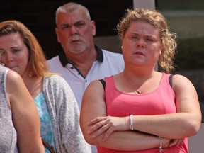 Casey Mackinlay weeps as she leaves the courthouse with her family Tuesday. Her common-law husband, Corby Stott, was killed in a parking lot road-rage incident at the Midland Walmart plaza on July 2, 2016.  Tracy McLaughlin photo)