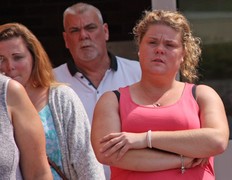 Casey Mackinlay weeps as she leaves the courthouse with her family Tuesday. Her common-law husband, Corby Stott, was killed in a parking lot road-rage incident at the Midland Walmart plaza on July 2, 2016. Tracy McLaughlin photo)
