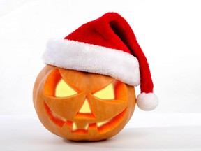 Halloween pumpkin shiny inside wearing christmas hat on white