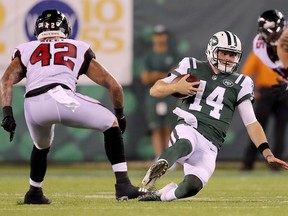 New York Jets' quarterback Sam Darnold carries the ball as Duke Riley of the Atlanta Falcons defends during a preseason game at MetLife Stadium on Aug. 10, 2018 in East Rutherford, N.J.