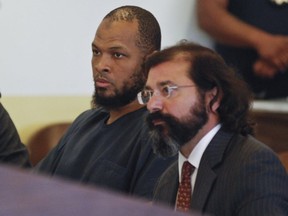 Siraj Ibn Wahhaj, left, sits next to public defense attorney Aleks Kostich.