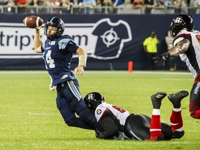 Toronto Argonauts quarterback McLeod Bethel-Thompson (14) is stopped by the Ottawa Redblacks defence line during fourth quarter CFL action in Toronto on Thursday, August, 2, 2018. THE CANADIAN PRESS/Christopher Katsarov