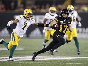 Hamilton Tiger-Cats Luke Tasker runs for a touchdown past Edmonton Eskimos Josh Woodman, left, during the second half of CFL football action in Hamilton, Ontario on Thursday August 23, 2018. THE CANADIAN PRESS/Mark Blinch