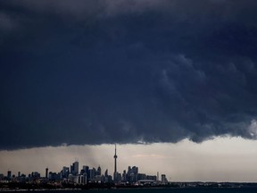 Storm clouds roll over the skyline in Toronto on Thursday, July 26, 2018.