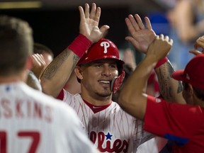 Wilson Ramos  of the Philadelphia Phillies high fives his teammates in the dugout after scoring a run in the bottom of the sixth inning against the Boston Red Sox at Citizens Bank Park on August 15, 2018 in Philadelphia, Pennsylvania. (Photo by Mitchell Leff/Getty Images)