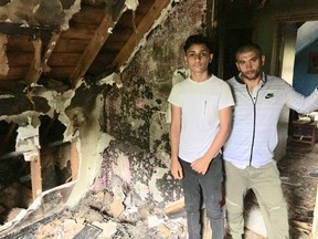 Erno Rumsznyak, right, a husband and father of seven, managed to get his family out of a North York house fire early Sunday morning. Szabolcs Laszlo, 14, and his parents and sister also escaped from the basement apartment (Kevin Connor/Toronto Sun)