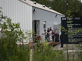 Asylum seekers enter a shelter on the Canadian side of Roxham Road, which starts near Champlain, N.Y. The outpost was built to help process the recent surge of refugees and asylum seekers, which can total about 50 people a day. MUST CREDIT: Photo for The Washington Post by Andre Malerba

N/A