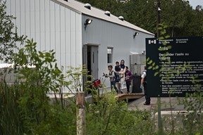 Asylum seekers enter a shelter on the Canadian side of Roxham Road, which starts near Champlain, N.Y. The outpost was built to help process the recent surge of refugees and asylum seekers, which can total about 50 people a day. (Andre Malerba/The Washington Post)