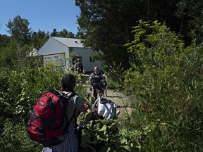 At the end of Roxham Road in Champlain, Fiyori Mesfin, 32, crosses into Canada with her 3-year-old son and 1-year-old daughter, both U.S. citizens. (The Washington Post/Andre Malerba)

N/A